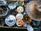 Colored thai food in floating market, food seller with traditional hat in Thailand