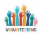 Colored volunteer crowd hands. Hand drawing lettering Volunteering. Raised hand silhouettes. Volunteer education poster mockup,