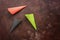 Colored waffle cones for ice cream on a dark rustic brown background. Green, black and red empty cone. Top view, flat lay, copy