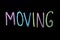 Colored word `moving` on chalkboard