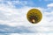 Colored yellow brown balloon with people flying into the sky with clouds. Little balloon adventure