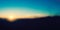 Colorful Abstract Blurry Image - Blue Sky, Sunset, Sun Over the Horizon in the Dusk, Darkness Closing - Wide Scale Background