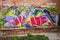 Colorful abstract graffiti text pattern on brick wall