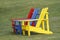 Colorful Adirondack chairs on green grass