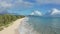 Colorful Aerial View of tropical beach with turquoise blue ocean water and waves lapping on hidden white sand beach