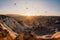Colorful air balloons flying over Cappadocia landscape at sunris