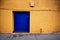 Colorful alley way wall with a blue door in Prescott Arizona