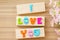 Colorful alphabet of LOVE wording on wooden background.