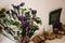 colorful amazing wildflowers in vase on background of rustic room