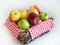 Colorful apples in wicker basket on white background
