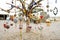 Colorful Arabian ornaments hanging on a dying tree with white background.