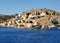 Colorful architecture of the buildings of the rocky shore of the island Symi