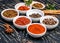 Colorful aromatic Indian spices and herbs on an old oak wooden deep blue board