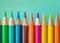 Colorful array of sharpened pencils lined up against a pastel background