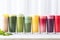 a colorful array of smoothies in various glasses
