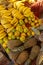 Colorful array of tropical fruits including pineapples, bananas, and oranges  on display