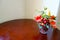 Colorful Artificial Yellow Orange Rose Vase on Wooden Table and