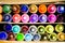 Colorful assortment of crayons in a shelf for a vibrant background or wallpaper