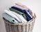 Colorful assortment of folded clothes neatly arranged in a wicker basket