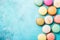 Colorful Assortment of French Macarons Arranged on a Pastel Blue Background