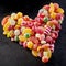Colorful assortment of sweets arranged as a heart