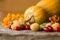 Colorful autumn decoration of pumpkins, yellow raspberries, dogwood and marigold.