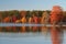 Colorful autumn landscape with forest reflected on lake