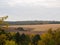 Colorful autumn landscape with views of the dramatic sky and fields. Nature, rural view of pretty farmland and plants in