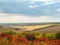 Colorful autumn landscape with views of the skyline and plowed field. Nature, rural autumnal view of pretty farmland and