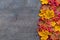 Colorful autumn plastic leaves on old wooden floor