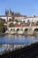 Colorful autumn Prague gothic Castle and Charles Bridge with the Lesser Town in the sunny Day, Czech Republic