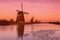 Colorful autumn scene in the famous Kinderdijk canals with windmills. Sunset in Dutch village Kinderdijk, Netherlands, Europe.