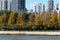 Colorful Autumn Trees on the Shore of Roosevelt Island with the Upper East Side Skyline in the background in New York City