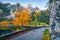 Colorful autumn view of Gosausee Vorderer lake with asphalt walkway road. Calm morning scene of Austrian Alps, Upper Austria, Eu