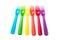 colorful baby plastic forks on white background