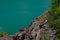 Colorful background emerald green water saturated with radon. Flooded granite quarry.