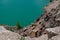 Colorful background emerald green water saturated with radon. Flooded granite quarry.