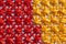 Colorful background of lots of bows tied from red and yellow ribbons. Fabric texture