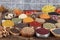 Colorful background with various herbs and spices for cooking in bowls. Seamless texture with spices and herbs