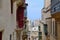Colorful balconies in narrow street in Valletta