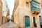 Colorful balconiew of the old stone houses. Narrow street of historical city, Malta