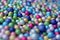 Colorful ball background made up of many small mostly blue foam balls