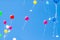 Colorful ballons with letters flying in the blue sky