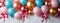 Colorful balloons and candles on white birthday backdrop