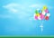 Colorful balloons flying over grass. Paper art and craft style