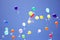 Colorful balloons with paper pigeons tied to them fly in the blue sky