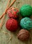 Colorful balls from wool and spokes on wooden