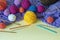 Colorful balls of wools, knitting needles and crochet hooks. Copy space