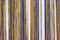 Colorful bamboo fence on wood texture for background