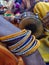 Colorful bangles in a hand, drummer blurry image behind it